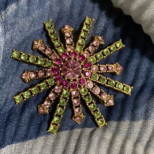 Express Star burst brooch in pink, green and fuchsia stones set.
